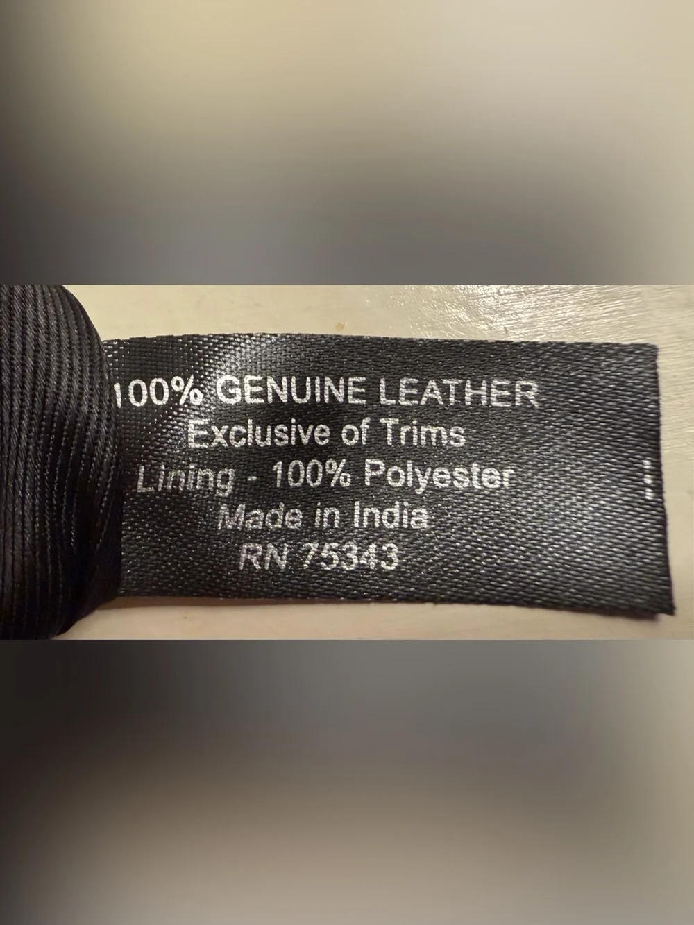 Leather wallet in black with woven flap closure.